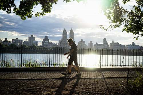 exercise two persons walking beside fence beside body of water human