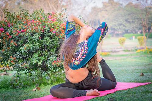 human woman wearing black pants and blue floral croptop girl