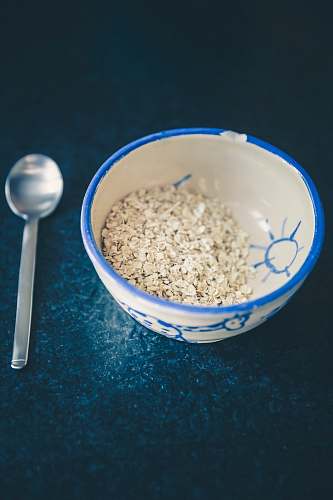 breakfast cereals in blue and white ceramic bowl oats