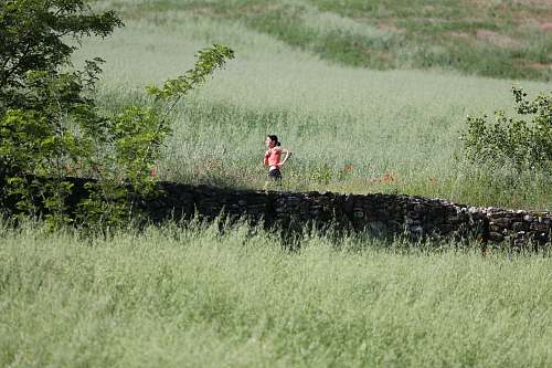 outdoors woman running through grass field