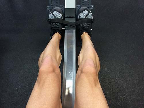 row person sitting on rowing machine crosstraining