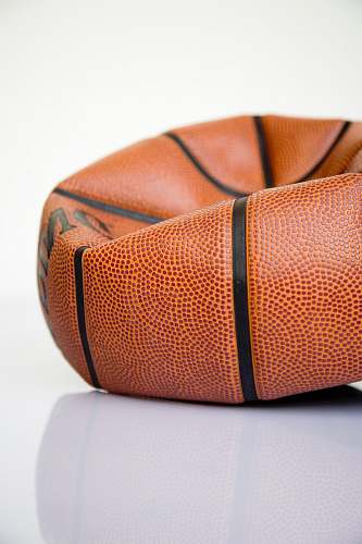 accessory brown basketball ball on white surface purse