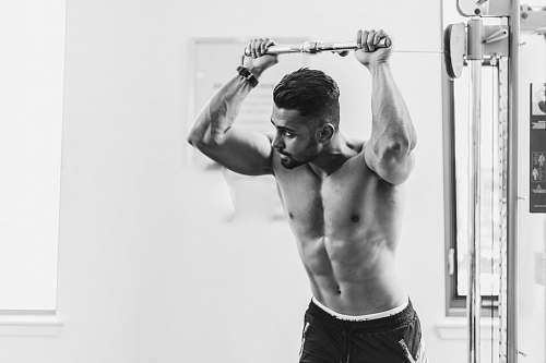 person grayscale photo of man in gym black-and-white