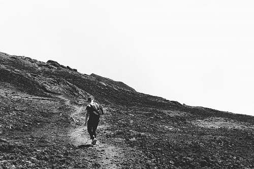 person grayscale photography of person hiking during daytime black-and-white