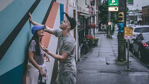 person man and woman near wall clothing