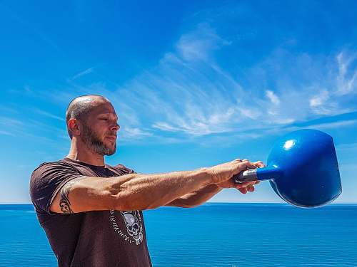 person man carrying blue kettle sphere