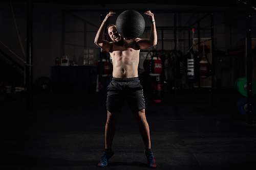 person man carrying stability ball people