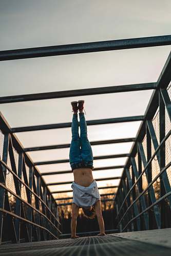 person man doing a handstand acrobatic