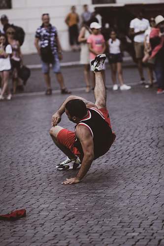 person man in red and black break dancing pedestrian