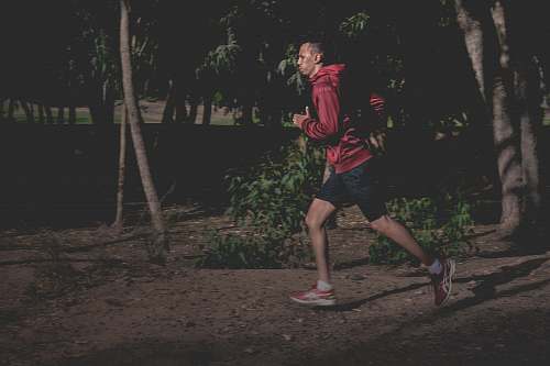person man in red hoodie running people