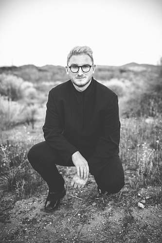 person man in suit kneeling black-and-white