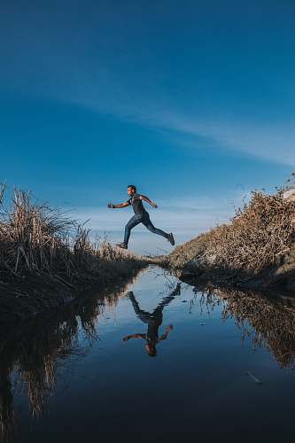 person man jumping over stream malaysia