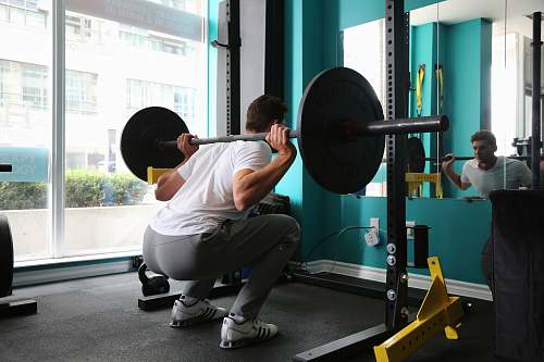 person man lifting barbel working out