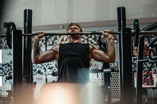 person man lifting barbell people