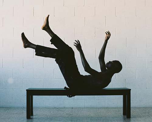 person man lying on black wooden table black