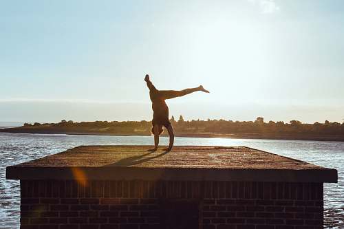 person man on gray platform dance pose