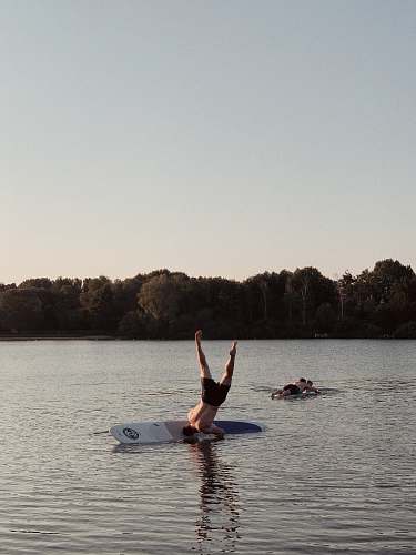 person man on surfboard during daytime water