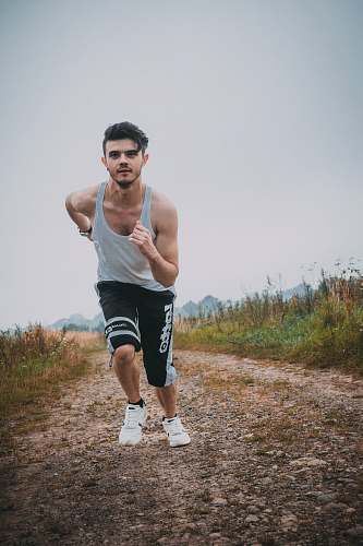 person man running beside green grass people