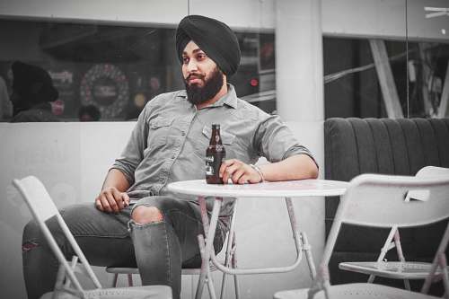 person man sitting on chair outside sitting