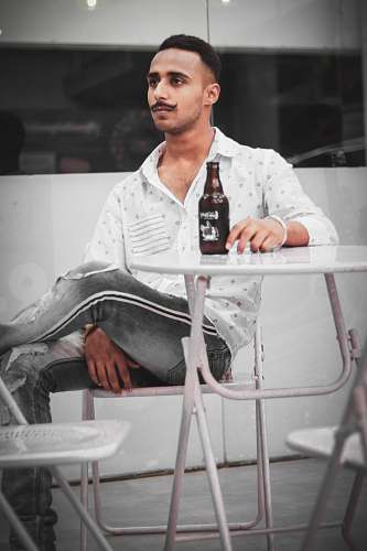 person man sitting on white chair sitting