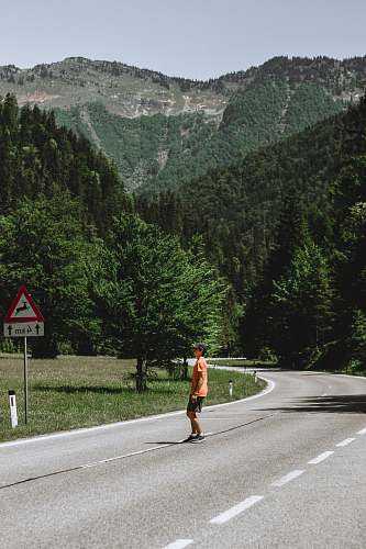 person man standing in middle of highway road