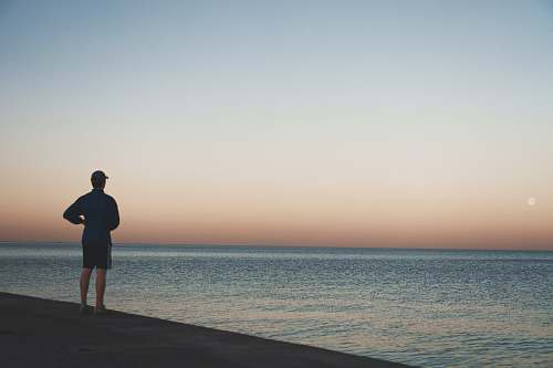 person man standing near sea standing