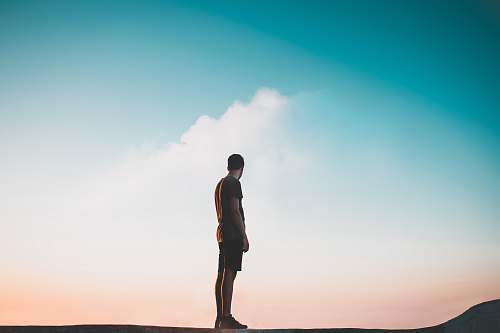 person man standing on flat surface during daytime people