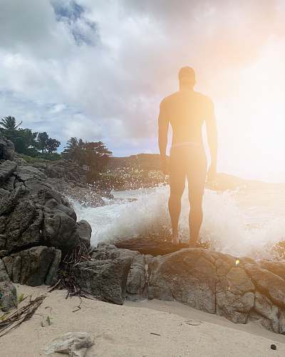 person man standing on rock flare