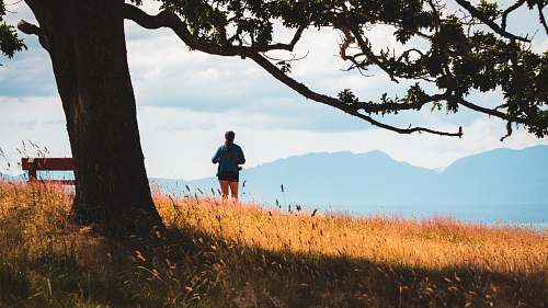 person man standing on the cliff watching the mountain working out
