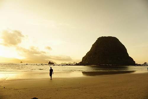person man walking near shores shoreline