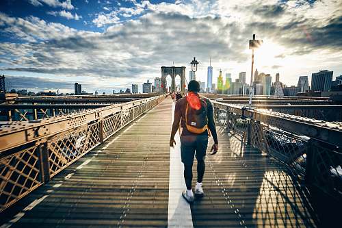 person man walking on bridge people
