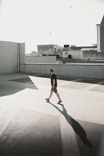 person man walking on building roof top people
