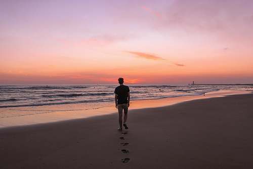 person man walking on shore exercise