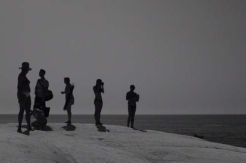 person people standing on beach black-and-white