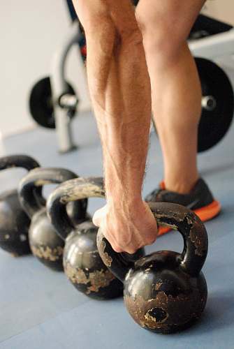 apparel person holding black kettlebell clothing