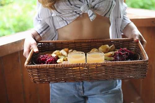 person person standing and carrying basket with juice and pastry plant
