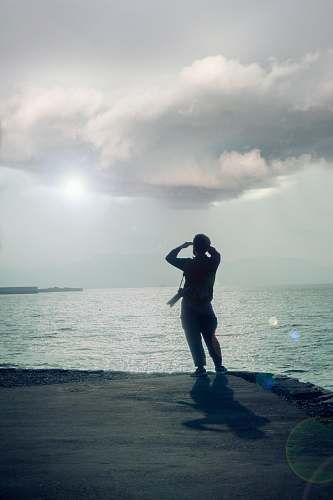 person person standing at the shore during daytime exercise