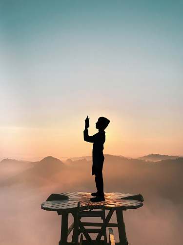 person person standing on brown tower nature