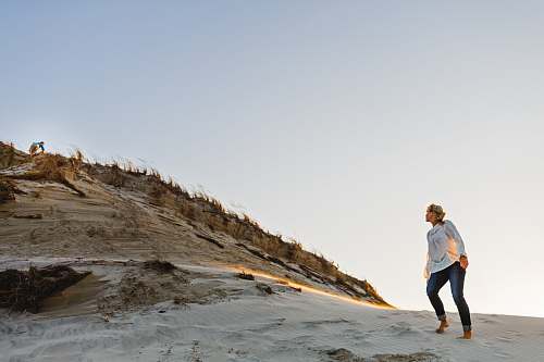 person person standing on mountainside during daytime exercise