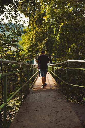 person person walking on bridge apparel