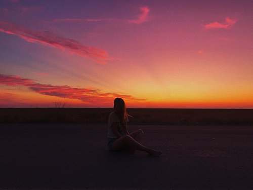 person silhouette of sitting woman nature