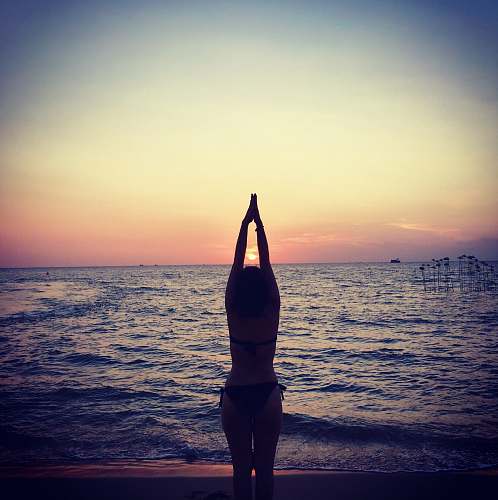 sports silhouette photography of woman raising her hands sport