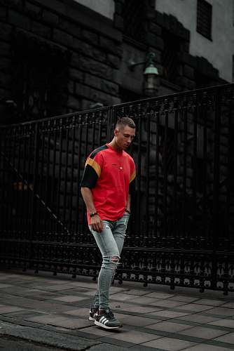 people standing man wearing red and black t-shirt person