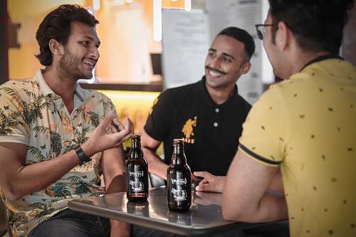 person three men drinking beer drink