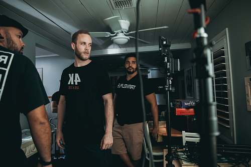 person three men standing inside room skin