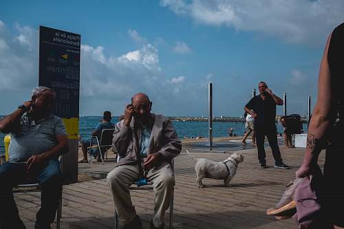 person two men sitting on chairs apparel