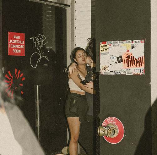 person two women kissing on corner apparel