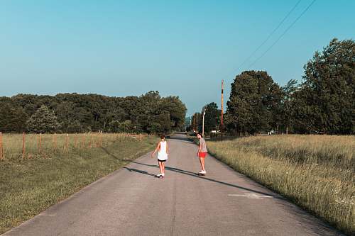 person unknown persons riding on skateboard outdoors road