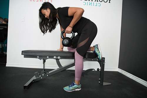 person woman carrying kettle bell exercise