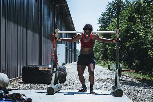 person woman carrying white gym equipment at daytime people
